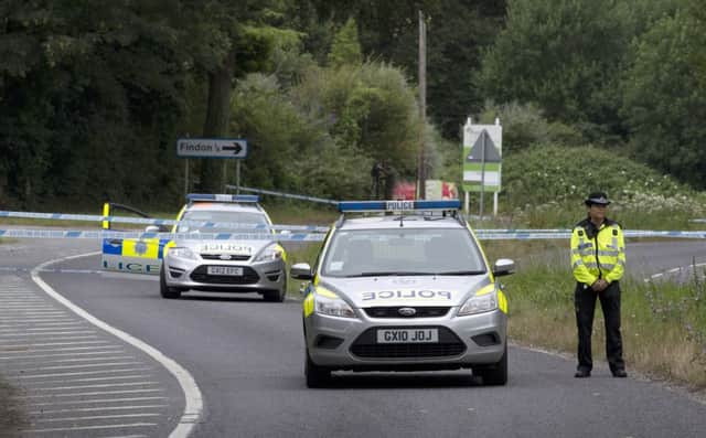 Police close to the scene where a man was stabbed to death by another motorist in Findon, West Sussex, following a crash.