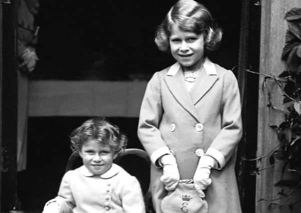 1933 picture of two-year-old Princess Margaret (seated) with her sister Princess Elizabeth, 7, as Buckingham Palace defended footage from 1933 that shows a young Queen performing a Nazi salute with her family at Balmoral.