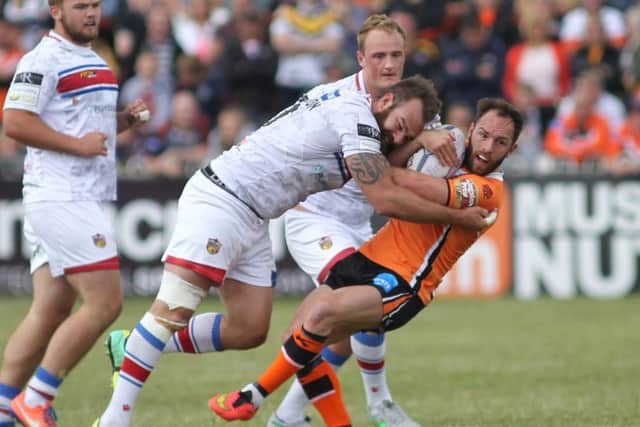Castleford's Luke Gale feels the full force of a Wakefield tackle.
