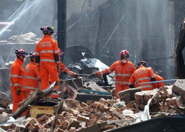 Search and rescue teams from all emergency services search the scene of the explosion