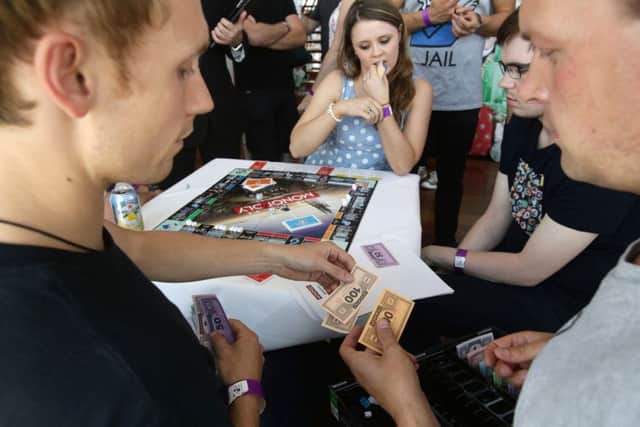 Eventual winner Natalie Fitzsimmons (centre), 24, from Saintfield, Northern Ireland, taking part in the UK and Irish finals of the Monopoly World Championships