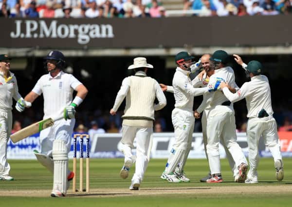 Australia's Nathan Lyon is congratulated by teammates on taking the wicket of England's Ian Bell for 11 during England's woeful second innings performance at Lord's on Sunday.
