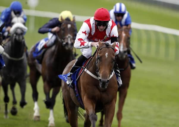 Custom Cut ridden by Daniel Tudhope (red cap) wins the Shadwell Joel Stakes earlier this year. Picture: Steve Parsons/PA.