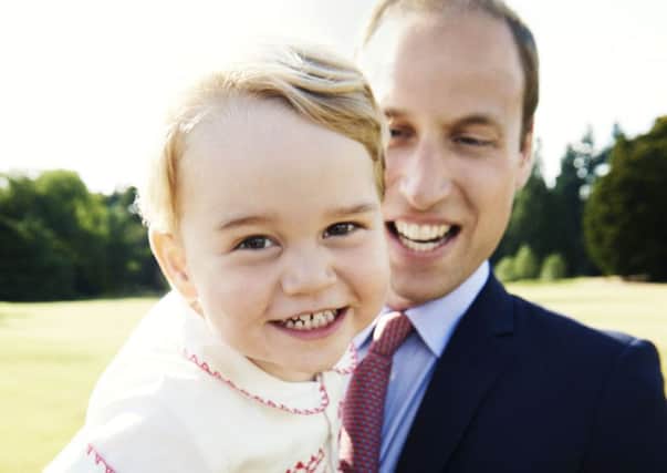 Prince George, who celebrates his second birthday on Tuesday, with his father, the Duke of Cambridge. The photograph was taken in the gardens at Sandringham House and was part of the series of official photographs taken by Mario Testino following Princess Charlotte's baptism