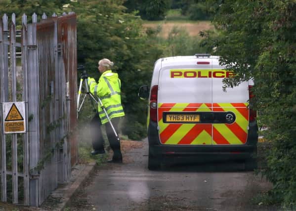 A police officer carries a tripod, at a North Yorkshire Water Treatment Plant in Tadcaster, North Yorkshire.