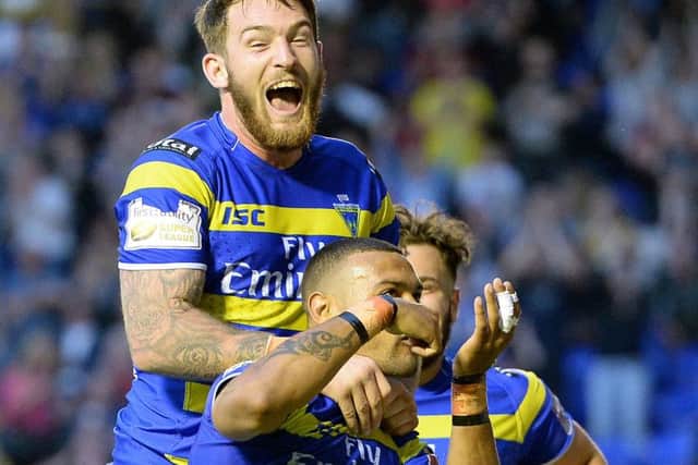 Warrington Wolves' Kevin Penny celebrates his try against St Helens with Daryl Clark (left)