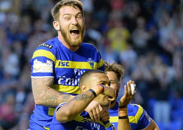 Warrington Wolves' Kevin Penny celebrates his try against St Helens with Daryl Clark (left)