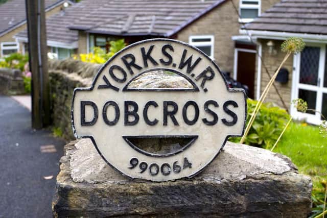An old Yorkshire West Riding road sign in the Saddleworth village of Dobcross.