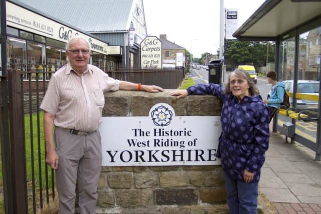 Geoff Bayley and Brenda Cockayne with their Yorkshire sign marking the old West Riding boundary. Its now in Oldham.