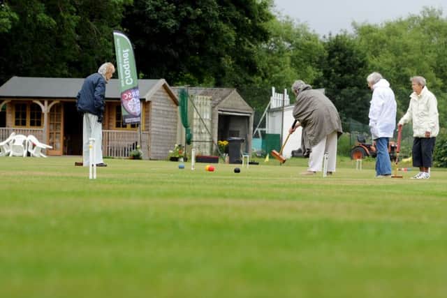 Rain cant stop play at Ben Rhydding Croquet Club as members carefully consider their next moves on the lawn.