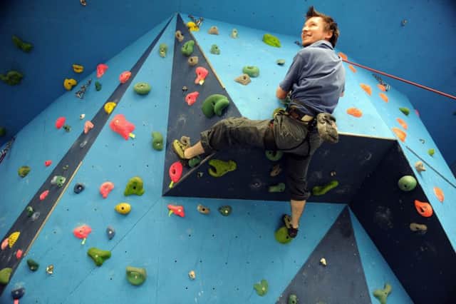 Labman Automation  employee  Jamie Marsay on the climbing wall inside their office at Seamer near Stokesley