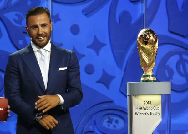 Italian soccer legend Fabio Cannavaro looks to the World Cup trophy during the preliminary draw for the 2018 soccer World Cup in St. Petersburg. Picture: PA.