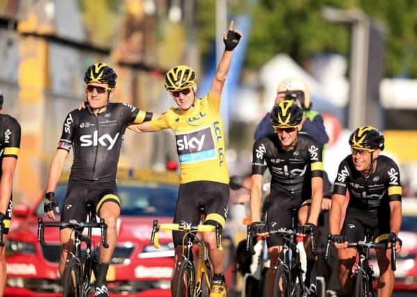 SWEET VICTORY: Team Sky's Chris Froome (yellow jersey) crosses the finish line with his team-mates at the end of the 2015 Tour de France. Picture: Mike Egerton/PA.