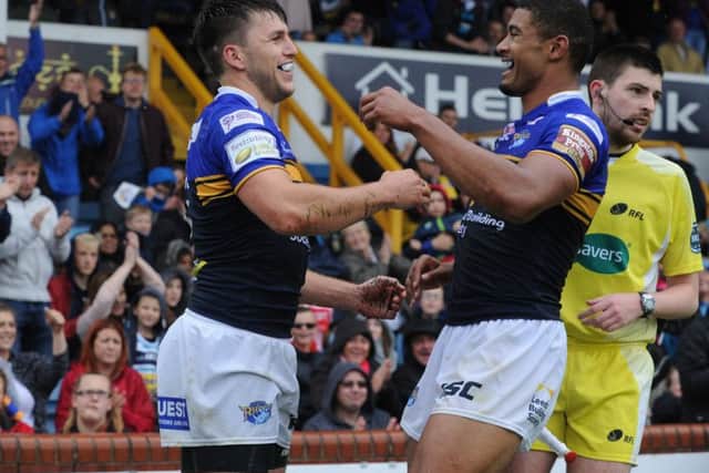 WELL DONE: Tom Briscoe is congratulated by Leeds Rhinos team-mate Kallum Watkins after scoring the second of his three tries against Catalans Dragons. Picture: Steve Riding.