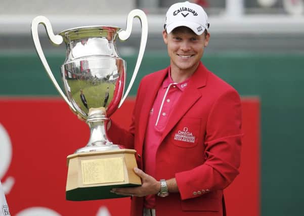 Winner Danny Willett of England poses with the trophy after the final round of the Omega European Masters golf tournament in Crans-Montana, Switzerland, Sunday, July 26, 2015. (Peter Klaunzer/Keystone via AP)