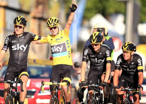 Team Sky's Chris Froome (yellow jersey) crosses the finish line with his team-mates. Picture: Mike Egerton/PA.