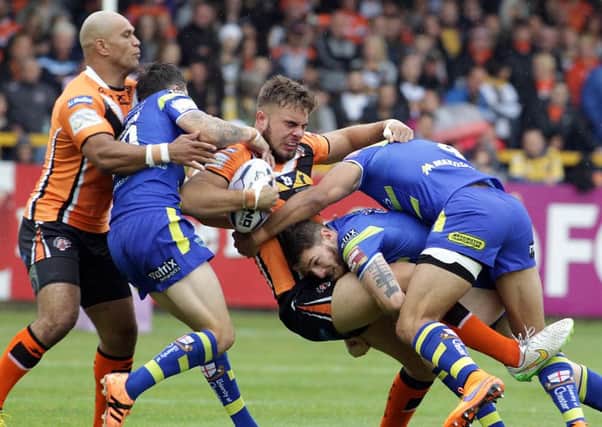 Castleford's Mike McMeeken is tackled by a pack of Wolves.