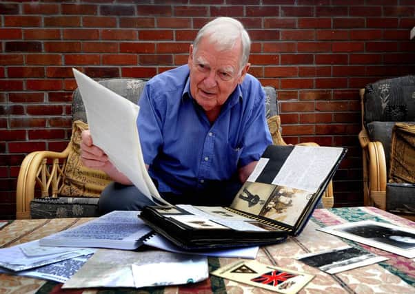 Pete Doughty going through his fathers scrapbooks.
