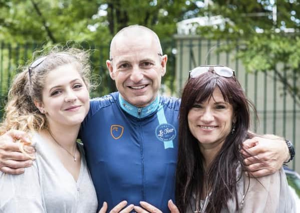 Simon Gueller with wife Rena (right) and daughter Zoe (left).