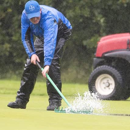 Rain water is swept off the 18th green at Alwoodley GC (Picture: Leaderboard Photography).