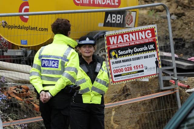Police at the entrance to a building site in Bank End Road, Worsbrough, Barnsley,  where the body of 7 year old Conley Thompson was found