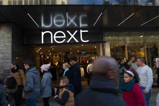 Next has hiked its full-year profit outlook after enjoying a warm weather boost to sales.