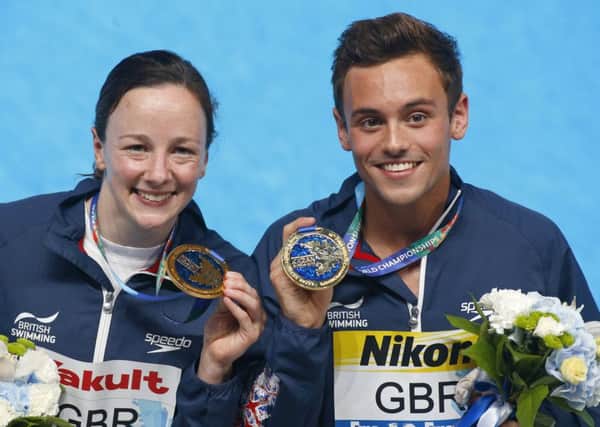 Britains Rebecca Galantree and Thomas Daley pose eith their gold medalsafter winning the Team Event diving final in Kazan. Picture: Sergei Grits/AP.