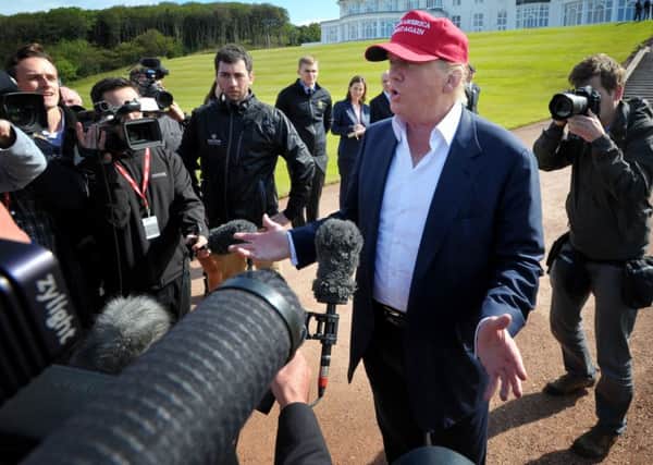 Donald Trump speaks to the media after arriving by helicopter at his Trump Turnberry golf course in Ayrshire.