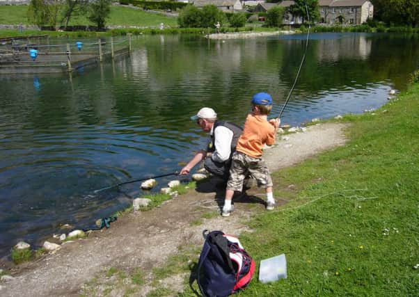 Stephen Cheetham teaching fly fishing student Alistair on his first ever lesson as a seven-year-old.