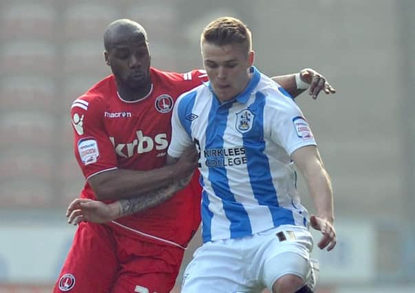 Charlton Athletic's Dany N'Guessan, right battles with Huddersfield Town's Danny Ward.