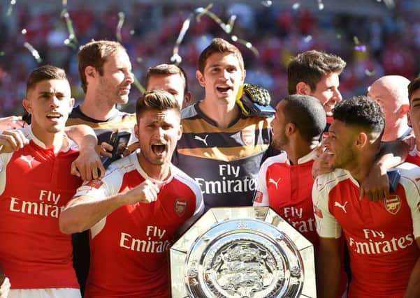 Arsenal celebrate victory with the trophy.