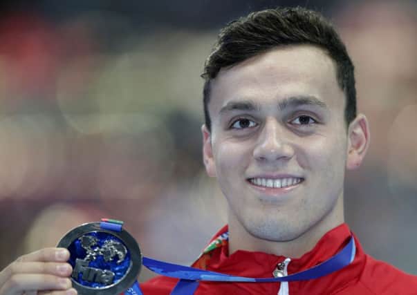 Britain's James Guy holds his silver medal.