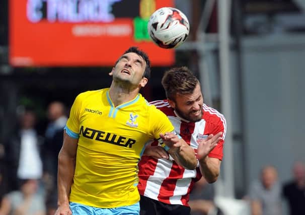 Crystal Palace's Mile Jedinak is challenged by Brentford's Stuart Dallas, who is now expected to sign for Leeds United. (Picture: Robin Parker/PA Wire)