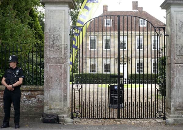 A police officer stands at the gate of Arundells, the former home of Sir Edward Heath in Salisbury, Wiltshire.