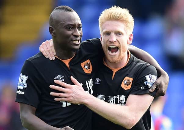Hull City's Dame N'Doye (left) is on the verge of leaving the KC Stadium.