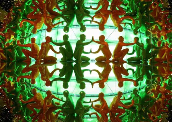 Morph-suited performers David Labanca and Gianmarco Pozzoli of Discoteque Machine in a giant  kaleidoscope
Picture: PA WIRE