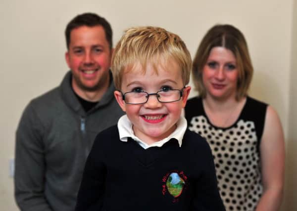Sam Brown, six, with his parents Katy and Simon, from Otley. Picture by Tony Johnson.