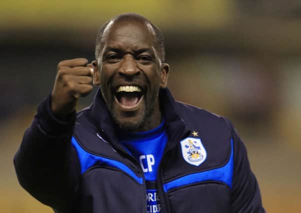 Huddersfield Town manager Chris Powell celebrates with fans after their 3-1 away win against Wolverhampton Wanderers, following the Sky Bet Championship match at the Molineux, Wolverhampton. PRESS ASSOCIATION Photo. Picture date: Tuesday October 1, 2014, See PA story SOCCER Wolves. Photo credit should read: Nick Potts/PA Wire. RESTRICTIONS: Editorial use only. Maximum 45 images during a match. No video emulation or promotion as 'live'. No use in games, competitions, merchandise, betting or single club/player services. No use with unofficial audio, video, data, fixtures or club/league logos.