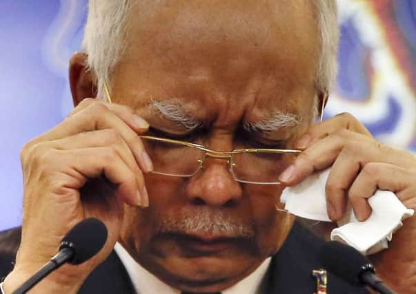 Malaysian Prime Minister Najib Razak, gestures before speaking at a special press conference announcing the findings for the ill fated flight MH370 in Kuala Lumpur, Malaysia,