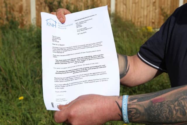 Paul Smith holds the letter he received from Kirklees Neighbourhood Housing. Picture shows Paul Smith at his privately-owned home was shocked - when she received a letter from authorities telling her to cut her GRASS. See Ross Parry copy RPYGRASS : Janne Shread was stunned when the strongly-worded letter arrived, which threatened "further action" if she didn't mow the lawn. The 43-year-old branded the council "hypocrites", saying they have failed to cut their own grass in the area's public areas. Janne, an admin worker from Mirfield, West Yorks., lives with partner Paul Smith who bought the property in 1996 from its previous owners who had bought it off the council.  rossparry.co.uk/Harry Whitehead