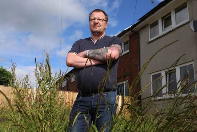 Paul Smith holds the letter he received from Kirklees Neighbourhood Housing. Picture shows Paul Smith at his privately-owned home was shocked - when she received a letter from authorities telling her to cut her GRASS. See Ross Parry copy RPYGRASS : Janne Shread was stunned when the strongly-worded letter arrived, which threatened "further action" if she didn't mow the lawn. The 43-year-old branded the council "hypocrites", saying they have failed to cut their own grass in the area's public areas. Janne, an admin worker from Mirfield, West Yorks., lives with partner Paul Smith who bought the property in 1996 from its previous owners who had bought it off the council.  rossparry.co.uk/Harry Whitehead