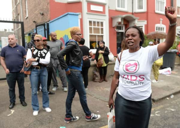 Members of staff leave for the final time as the Kids Company closes its building in Camberwell, London.