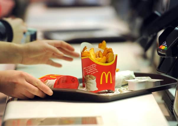 McDonald's is to offer table service for the first time in the UK as it seeks to ward off competition from upmarket burger chains.