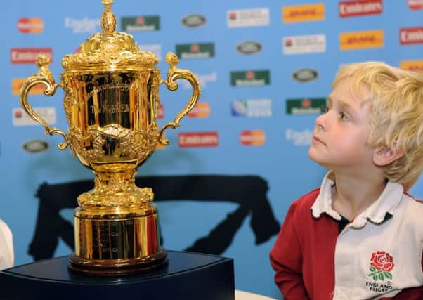 Toby Hopes, five, from Allerton Bywater near Leeds, with The Webb Ellis Trophy at Leeds Cental Library