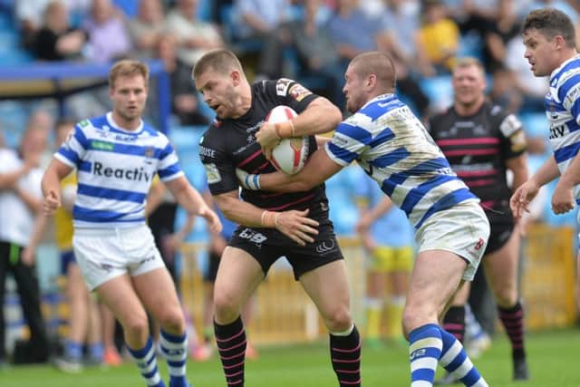 Widnes Vikings' Rhys Hanbury is tackled by Halifax's Ben Heaton during the Super League Qualifying match at The Shay, Halifax. (Picture: Anna Gowthorpe)