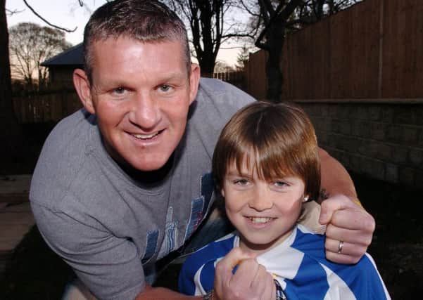 Bradford City striker Dean Windass with his son Joshua, 11, who plays for Huddersfield Town's U12 Academy side, pictured in 2005. Ten years on, Josh lines up against Hull City as an Accrington Stanley player.