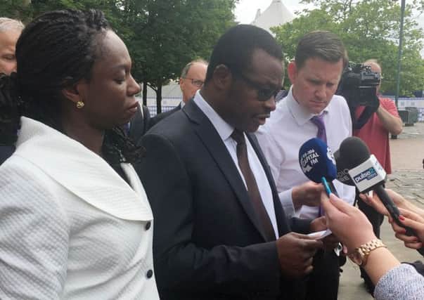 Vincent Uzomah, with his wife  Uduak, making a statement outside Bradford Crown Court