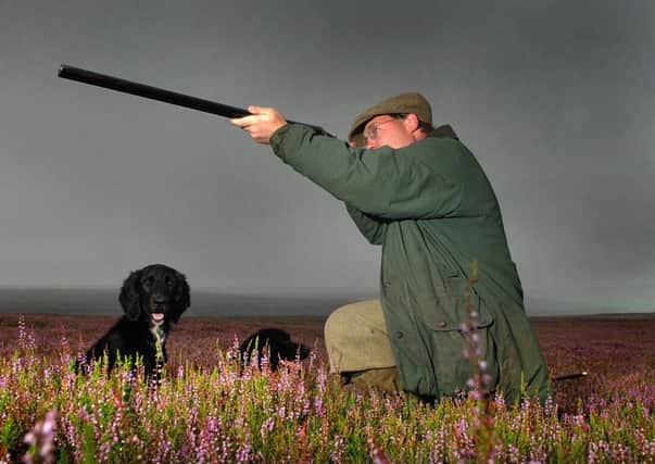 Grouse shoot member Adrian Thornton Berry pictured with his dogs at Arkengarthdale, for the Glorious 12th Grouse Shoot. 12th August 2003.