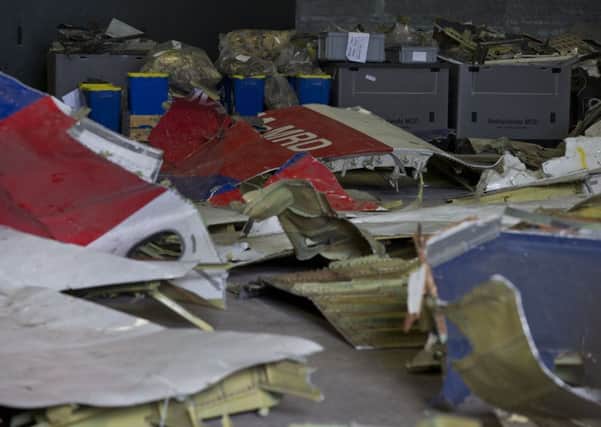 Parts of the wreckage of the Malaysia Airlines Flight 17 displayed in a hangar at Gilze-Rijen airbase, Netherlands.  Pic: AP Photo/Peter Dejong, File)