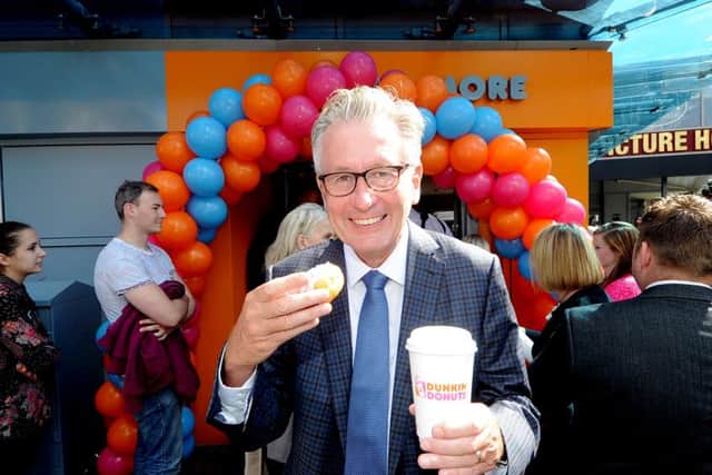 All smiles: Nigel Travis, CEO of Dunkin Brands, at the opening of the Dunkin' Donuts store in Leeds. Picture: James Hardisty, (JH1009/78e)